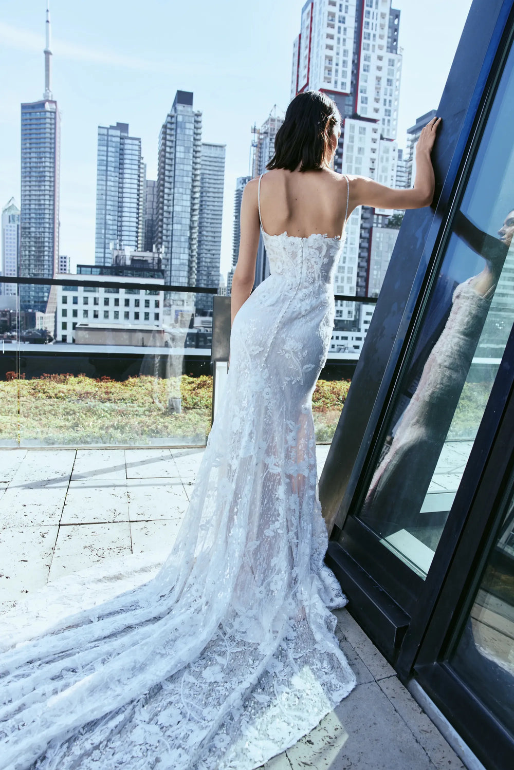 full back of rivini dove nude lace fitted wedding dress showing the open back and long train