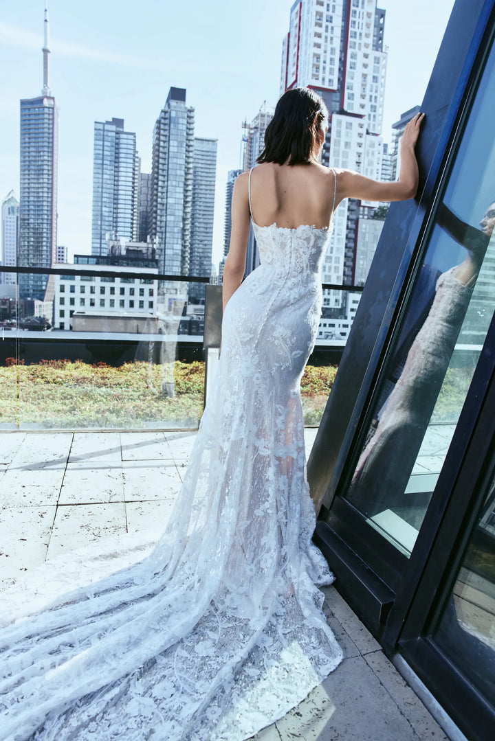 full back of rivini dove nude lace fitted wedding dress showing the open back and long train