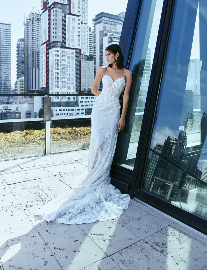 full front of rivini dove nude lace fitted wedding dress showing the sweetheart neckline, thin straps, and flowy skirt