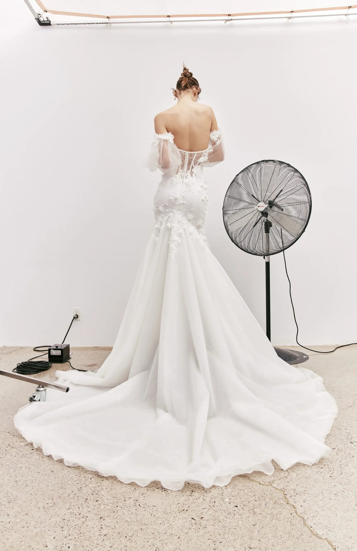 full back of rivini jax ivory lace fit and flare wedding dress featuring sheer back and chapel length train