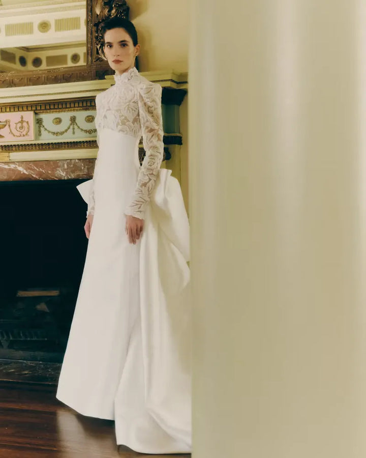 full front of rivini kit ivory satin fitted wedding dress with a lace bodice and matching overskirt with a bow