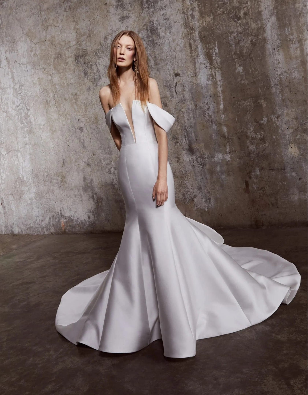 front of rivini phoebe ivory satin fit and flare wedding dress showing the full front with the plunge neckline and flared skirt