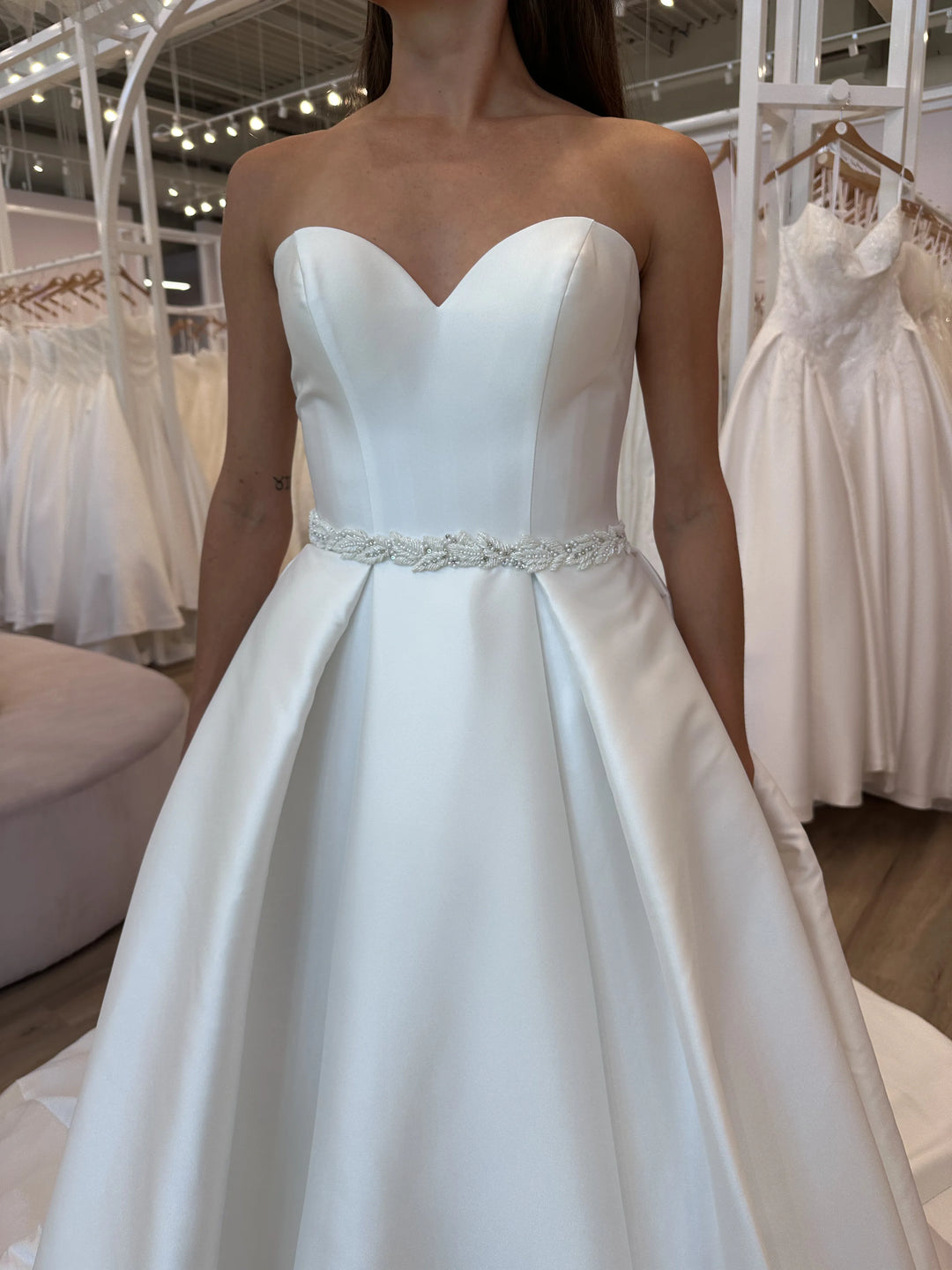 Full front of Luxe Privée Sierra Belt ivory satin A-line gown with leafy beaded belt and sweetheart neckline