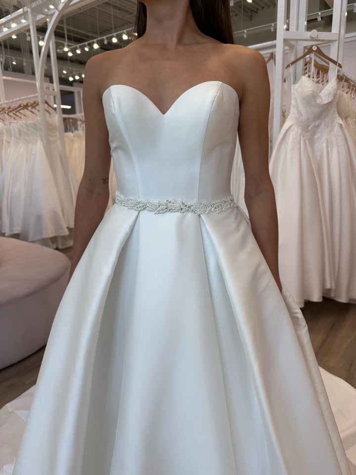 Full front of Luxe Privée Sierra Belt ivory satin A-line gown with leafy beaded belt and sweetheart neckline