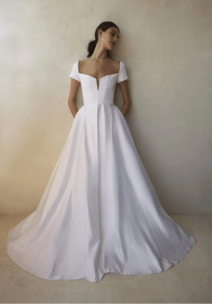Full front of Sarah Seven Grace white crepe A-line gown with square neckline and cap sleeves