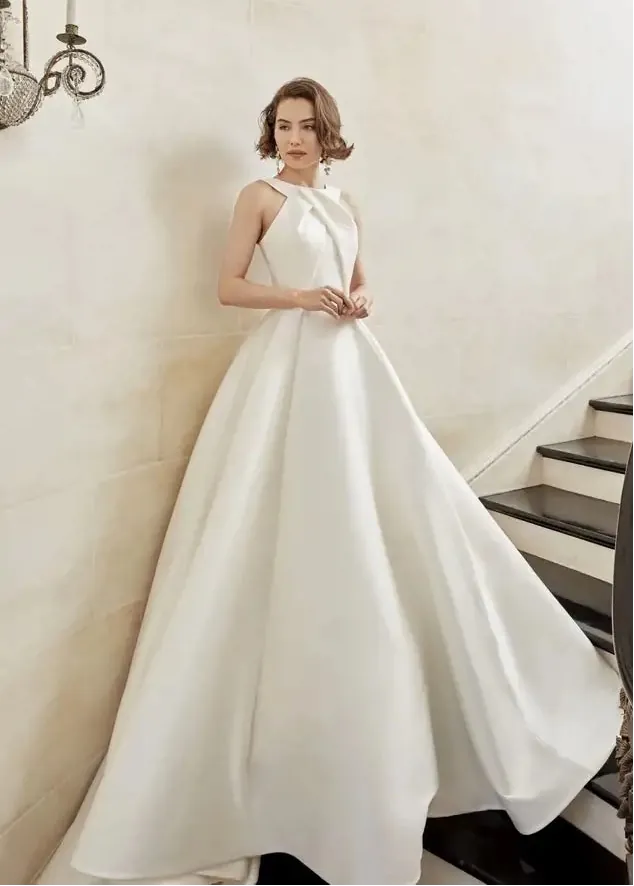 Woman in a white dress standing on a staircase