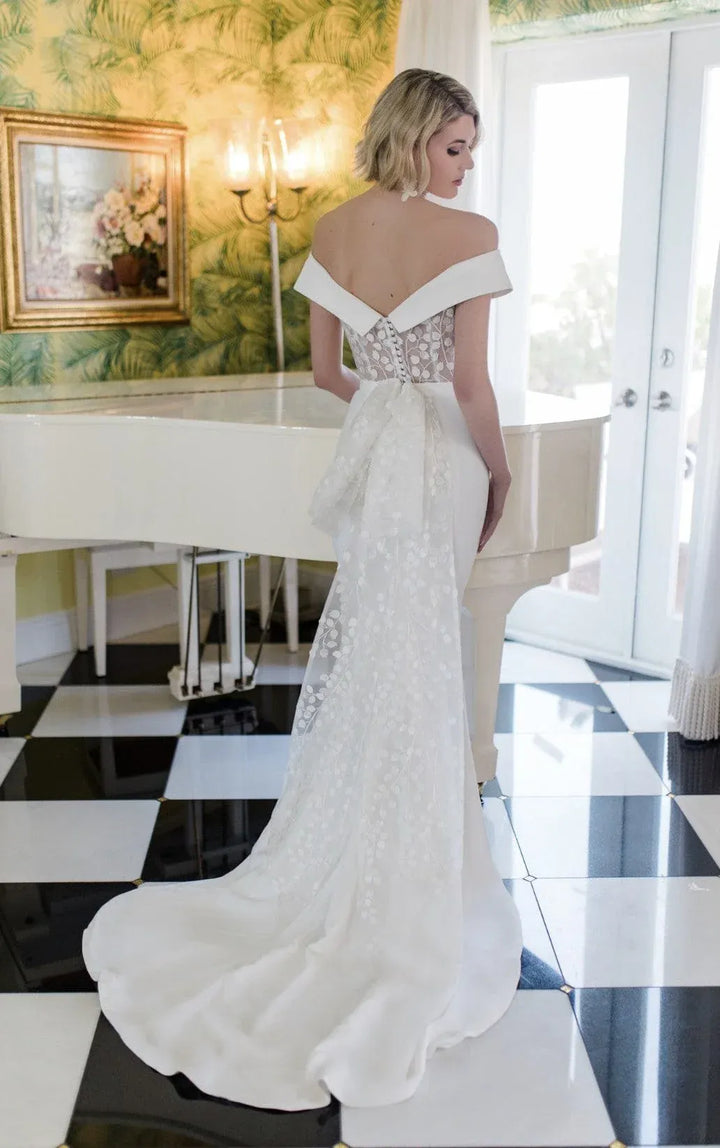 full back of savin london diana v2 ivory crepe fitted wedding dress with lace accents and a bow at the back