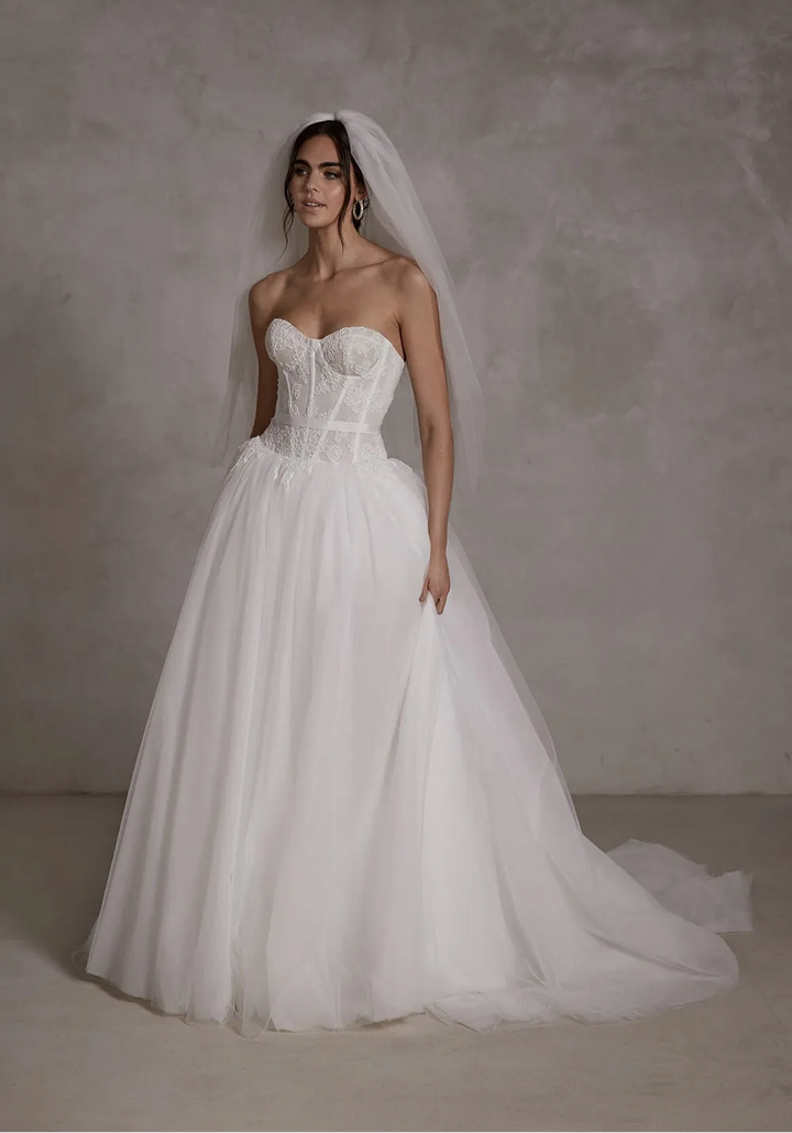 full front of seraphine gabrielle ivory tulle ball gown wedding dress with a drop waist and floral lace accents