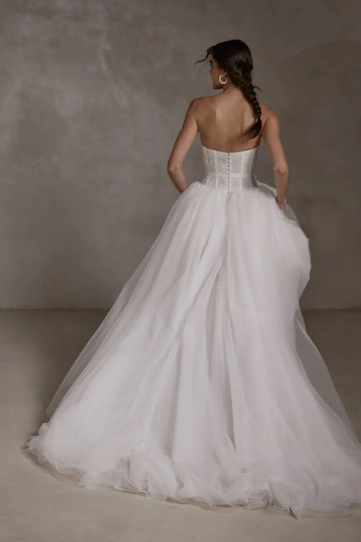 full back of seraphine gabrielle ivory tulle ball gown wedding dress with a drop waist and floral lace accents