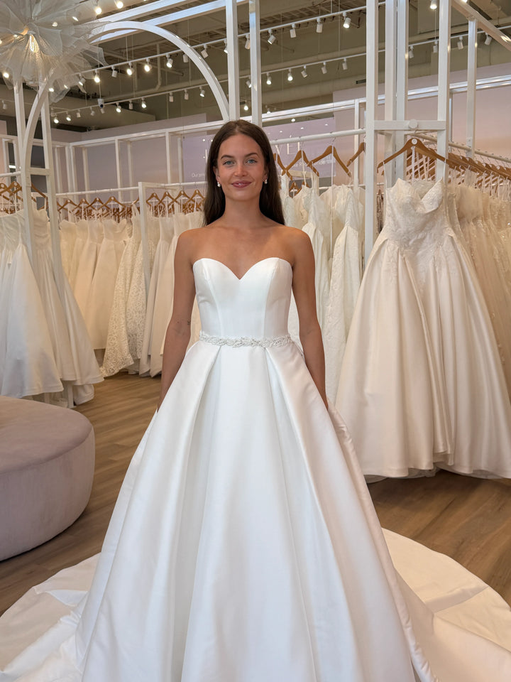 Full front of Luxe Privée Sierra Belt in ivory beaded trim on a satin A-line gown with leafy accents and sparkling beads