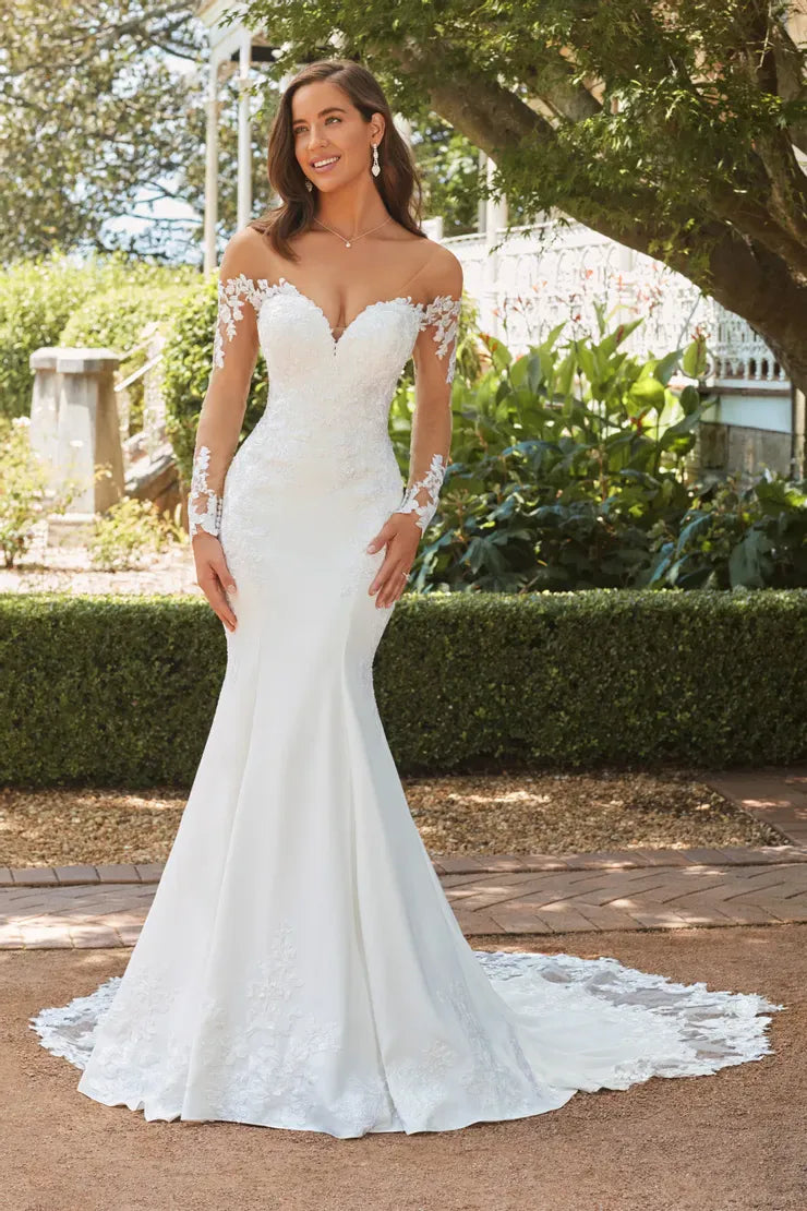 full front of sophia tolli clementine ivory crepe fit and flare wedding dress featuring sheer long sleeves and lace accents