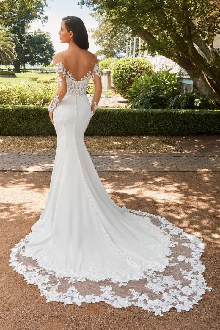 full back of sophia tolli clementine ivory crepe fit and flare wedding dress featuring sheer long sleeves and a shaped lace train