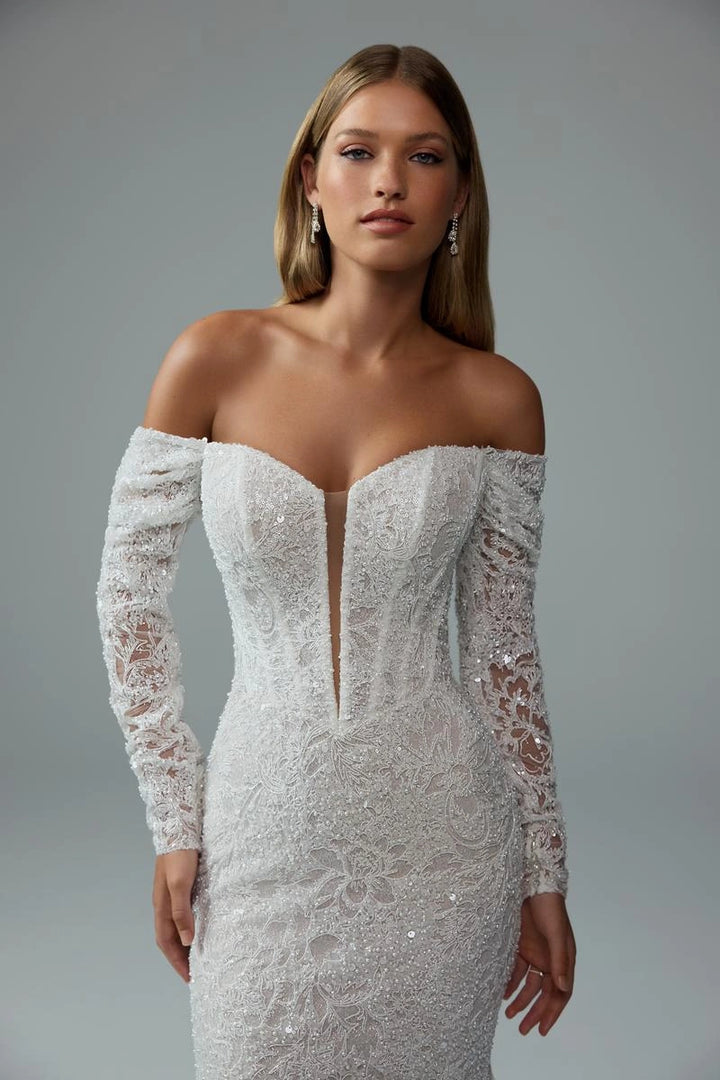 close up of sophia tolli premiere st661 ivory beaded lace fit and flare wedding dress showing the plunge bodice with detachable off the shoulder long sleeves