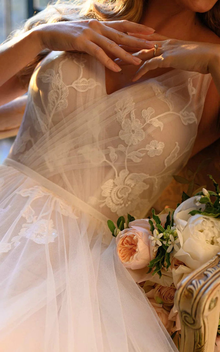 close up of stella york 7126 moscato tulle a-line wedding dress showing the v neck bodice and lace details