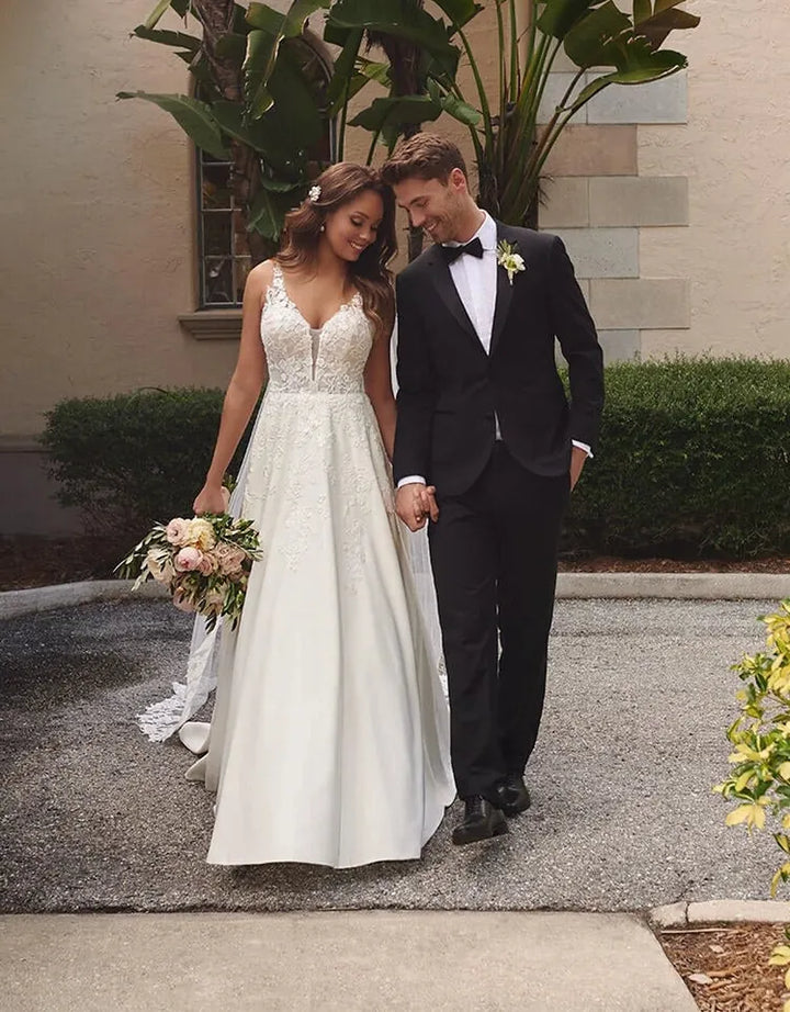full front of stella york 7198 ivory satin ball gown featuring cascading floral lace appliques on the deep v neckline bodice