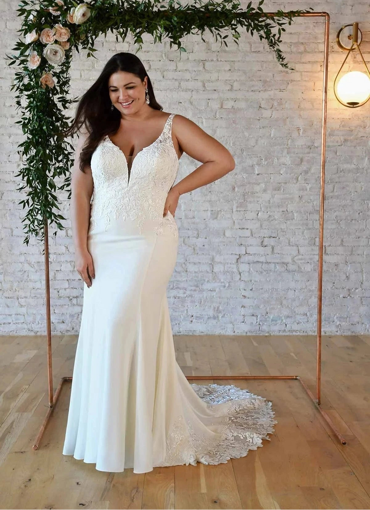 front of stella york 7335 ivory crepe fitted wedding dress, showing the full front with v neck bodice with lace details, and fitted skirt