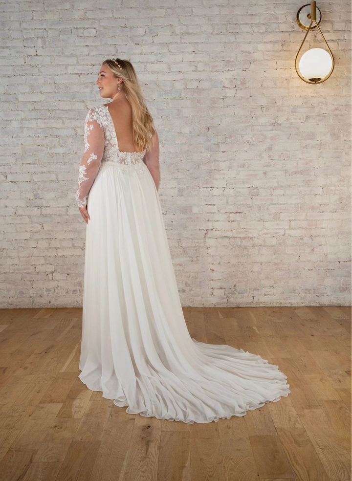 back of stella york 7699 ivory chiffon a-line wedding dress with sheer long sleeves and floral lace applique, and a short train