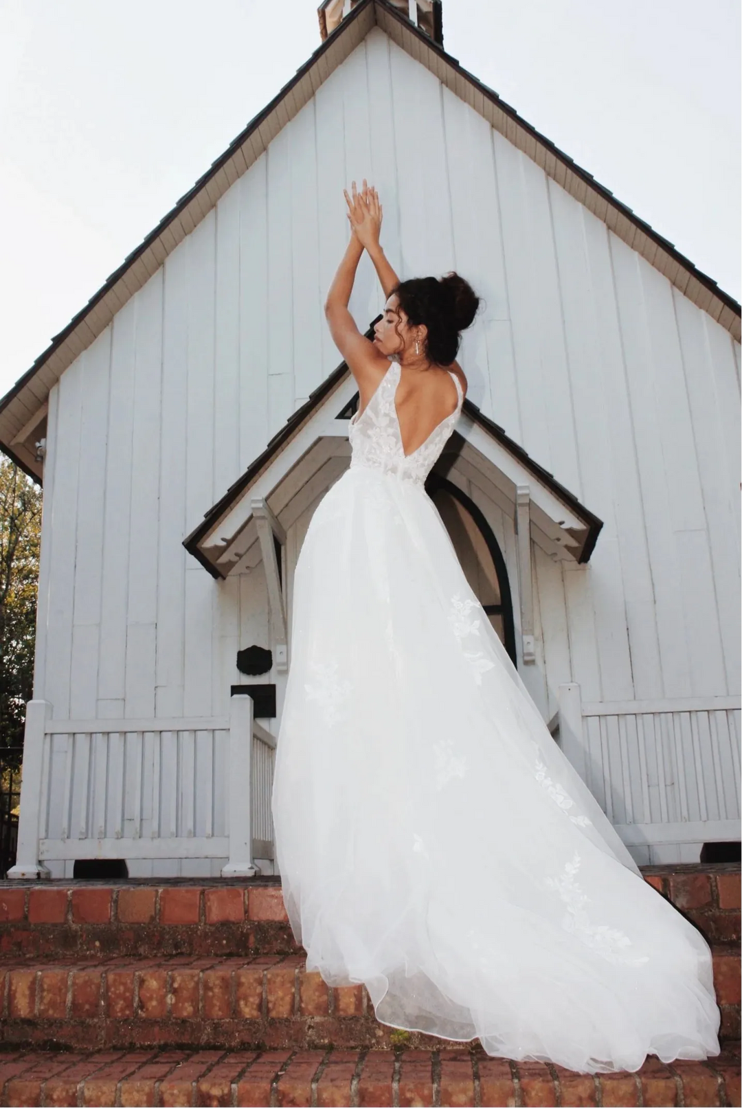 full back of stella york 7794 nude tulle a-line wedding dress with scattered floral lace and a v neckline, and a flowy train