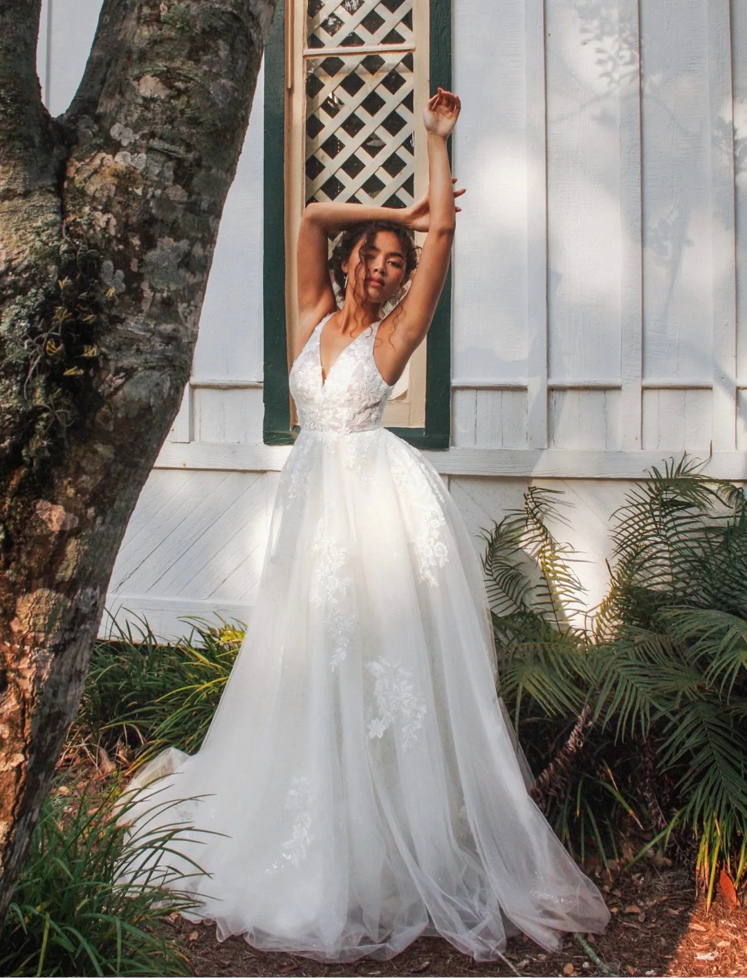 full front of stella york 7794 nude tulle a-line wedding dress with scattered floral lace and a v neckline