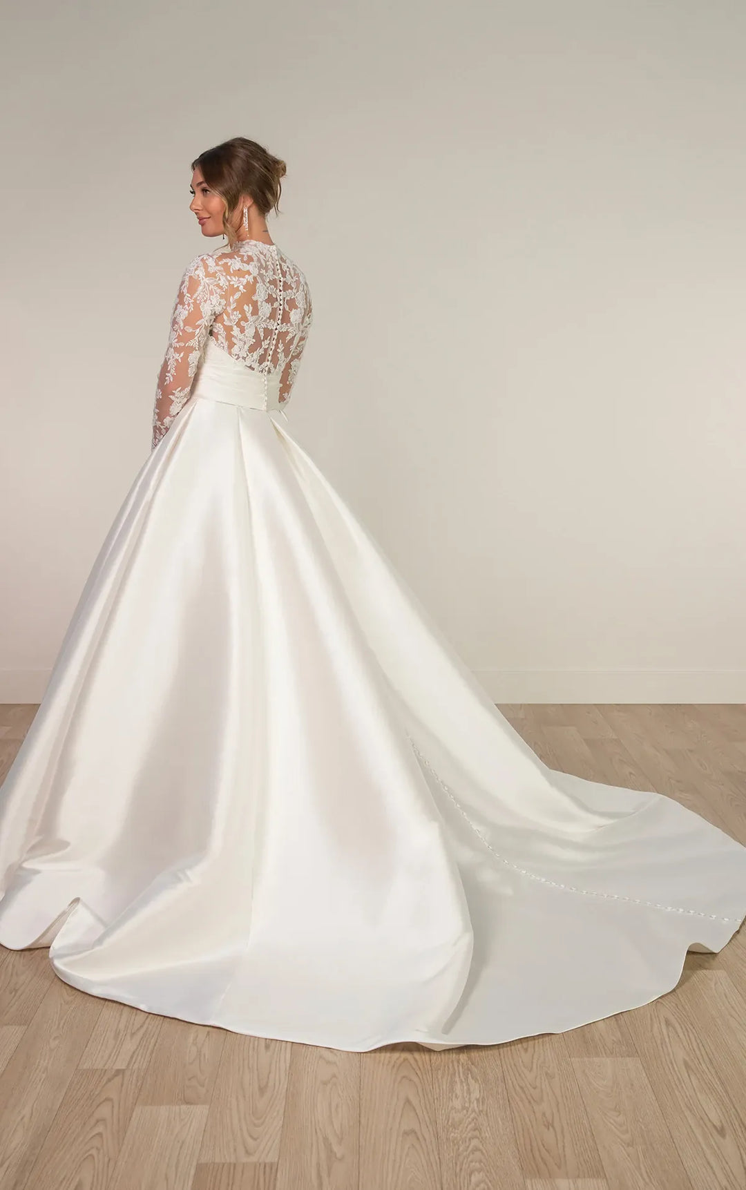 full back of stella york 8230 ivory mikado a-line wedding dress featuring a sheer lace bodice with a high neckline and long sleeves, and a chapel length train