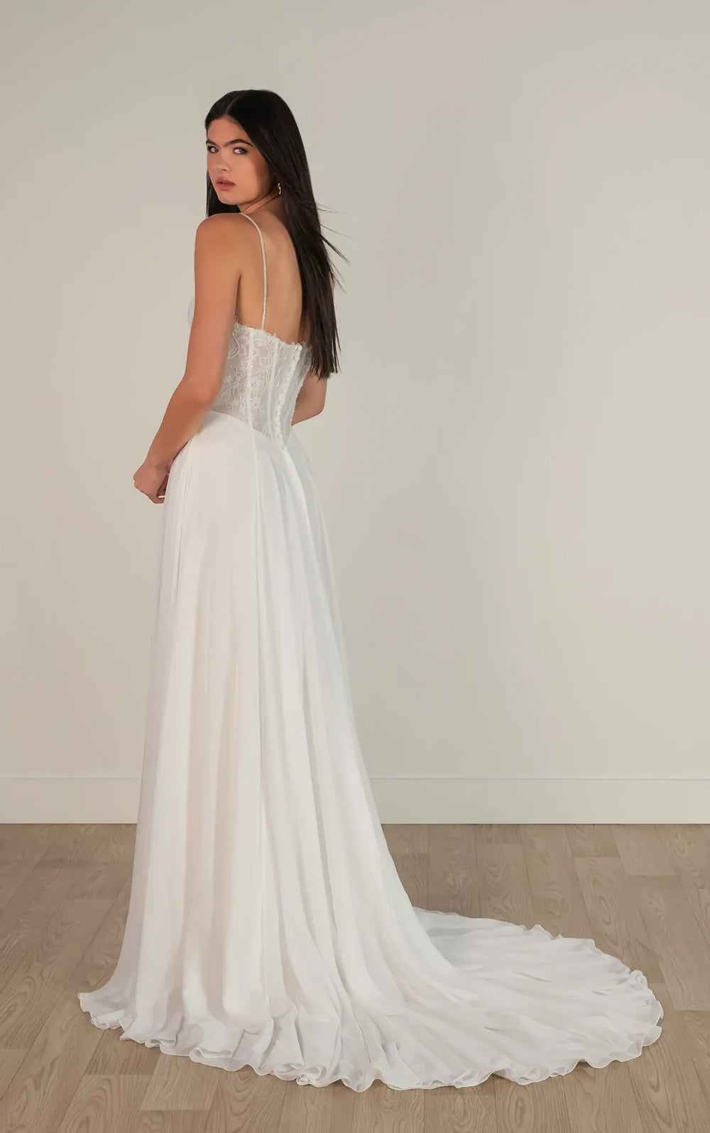 Woman wearing a white wedding dress with a plain background