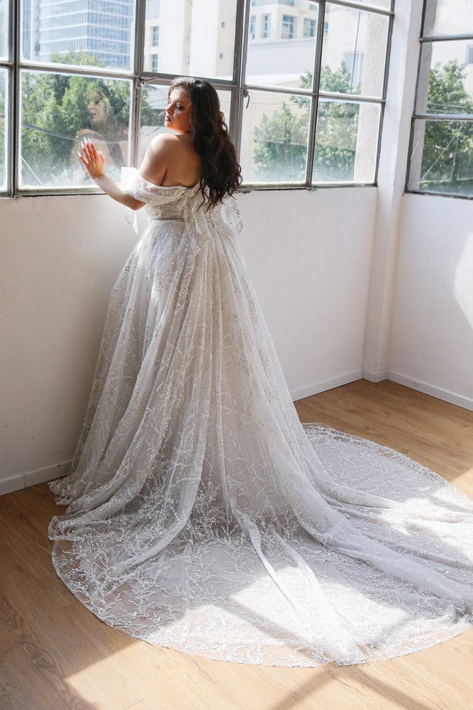 back of studio levana anna ivory lace a-line wedding dress with full length circle train