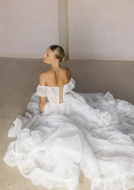 back of tal kedem sunset ivory dotted tulle a-line wedding dress, showing the lace up back and dotted tulle fabric