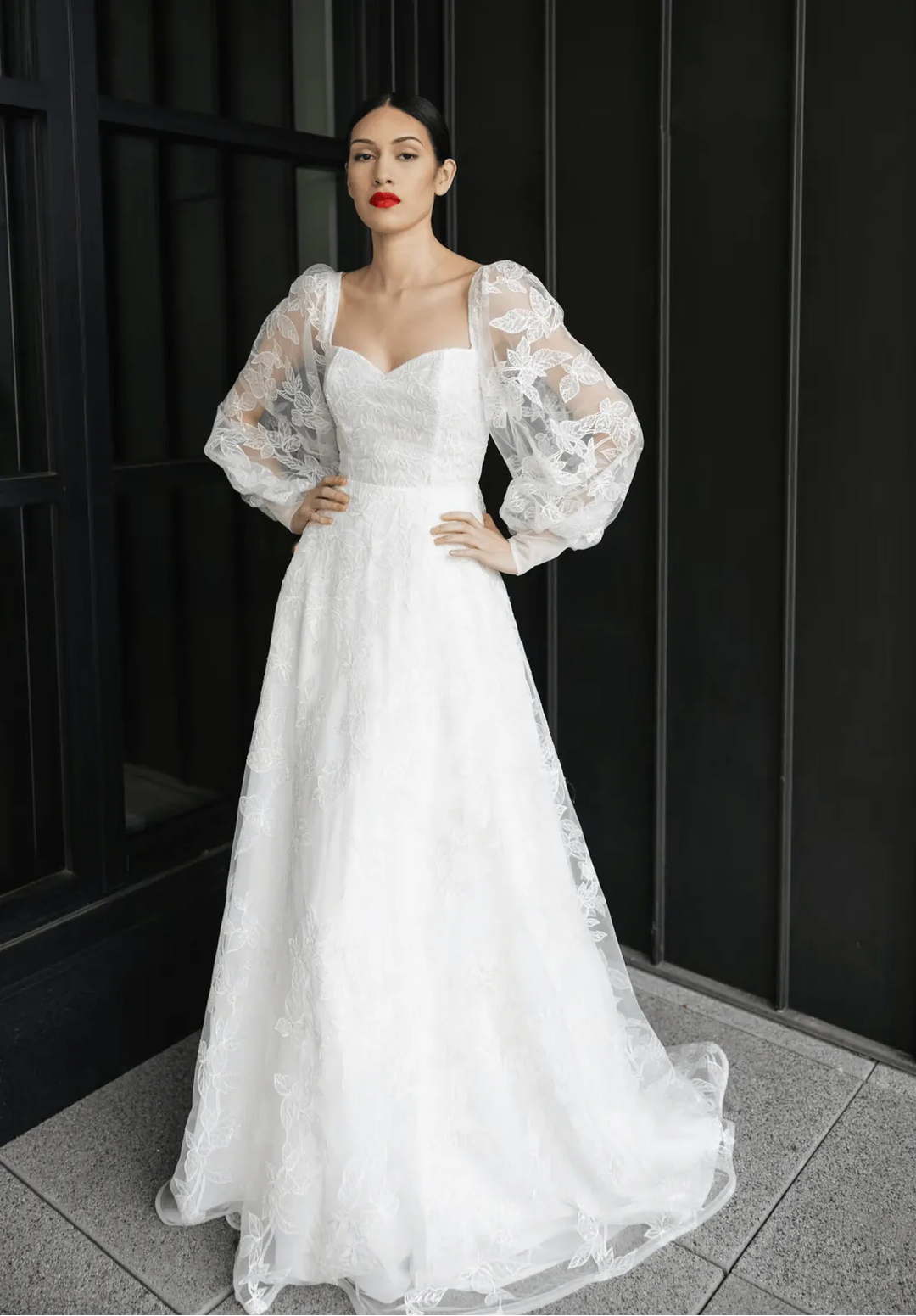 full front of tara latour georgie ivory lace a-line wedding dress with a sweetheart neckline and long billowing sleeves