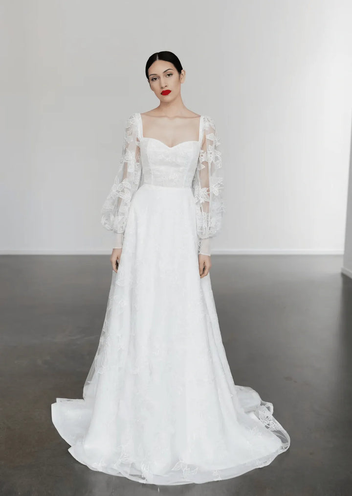 full front of tara latour georgie ivory lace a-line wedding dress with a sweetheart neckline and long billowing sleeves