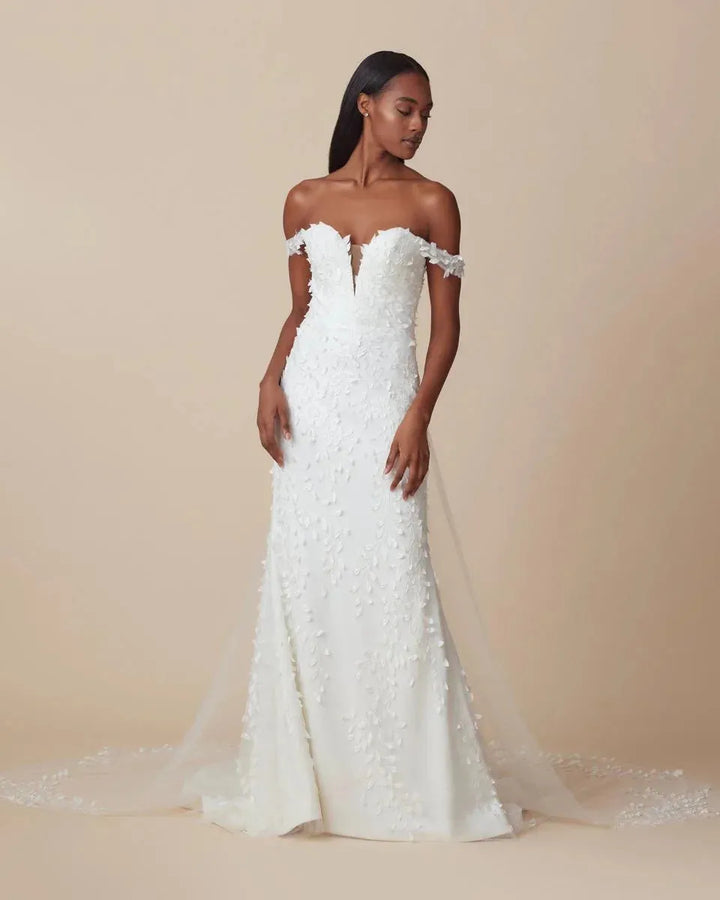 front of ti adora maya ivory crepe fitted wedding dress with floral lace embellishments and an off the shoulder neckline