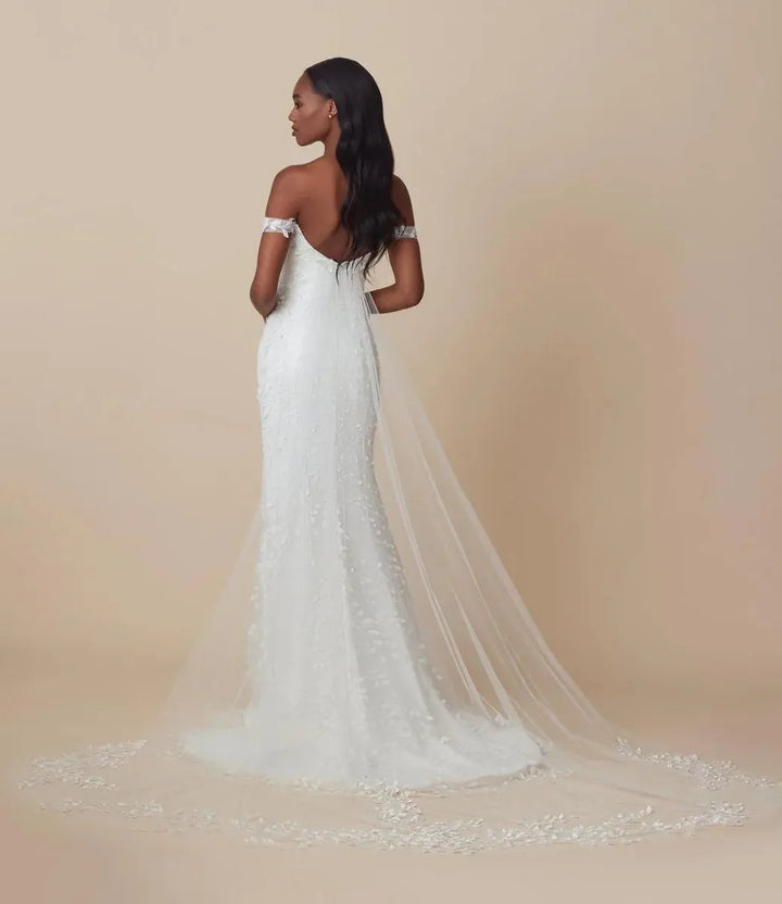 back of ti adora maya ivory crepe fitted wedding dress with floral lace embellishments and a detachable sheer tulle train