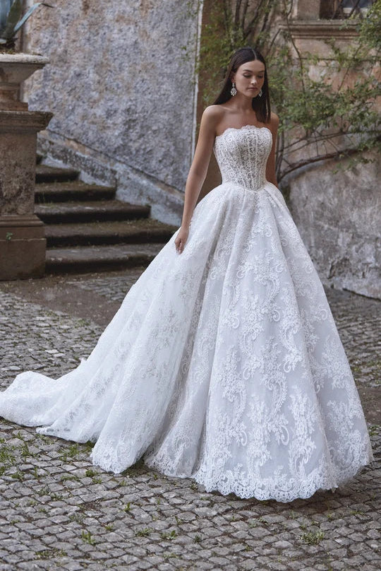 full front of veni infantino ayra ivory lace ball gown wedding dress featuring a basque waist, scalloped neckline, and full skirt