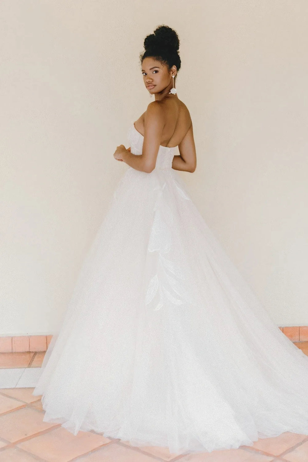 Woman in a white wedding dress with a plain background