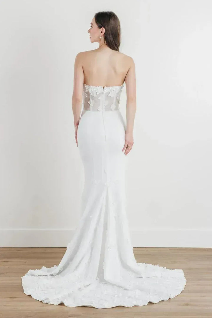 full front of locket by watters malia ivory crepe fitted wedding dress featuring dimensional lace accents and a short train