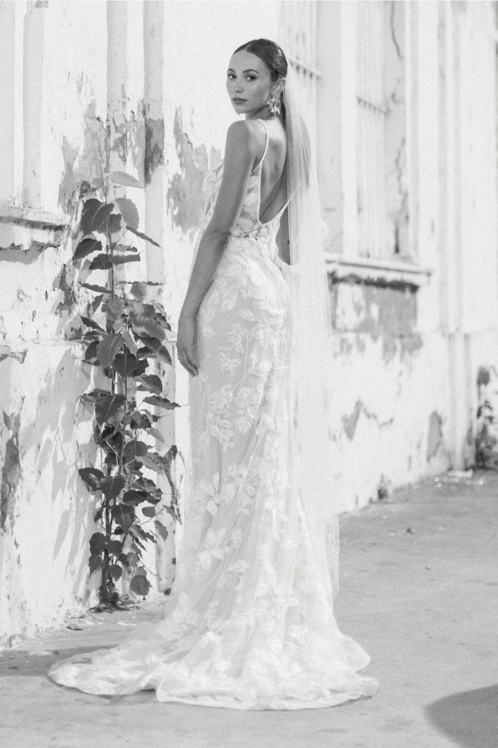 full back of locket by watters paloma blush lace sheath wedding dress with an open back and floor length skirt