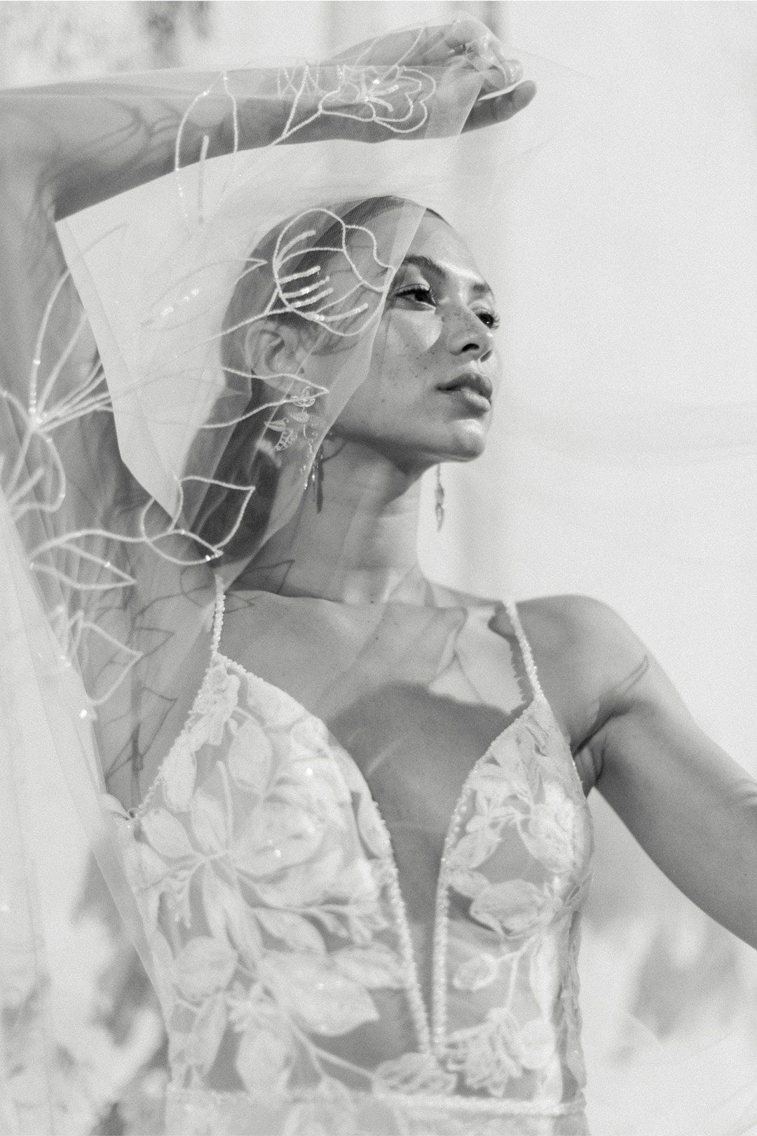 close up of locket by watters paloma blush lace sheath wedding dress showing the deep v neckline