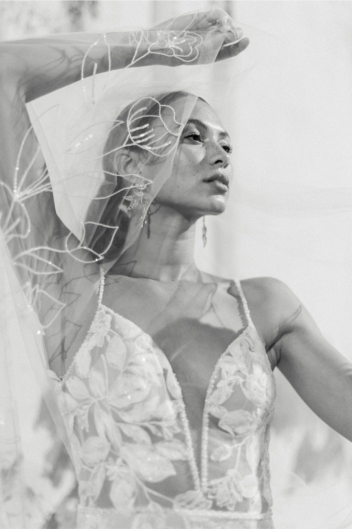 close up of locket by watters paloma blush lace sheath wedding dress showing the deep v neckline
