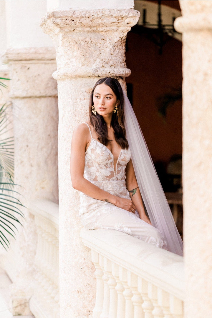close up of locket by watters paloma blush lace sheath wedding dress showing the lace print and v neck bodice