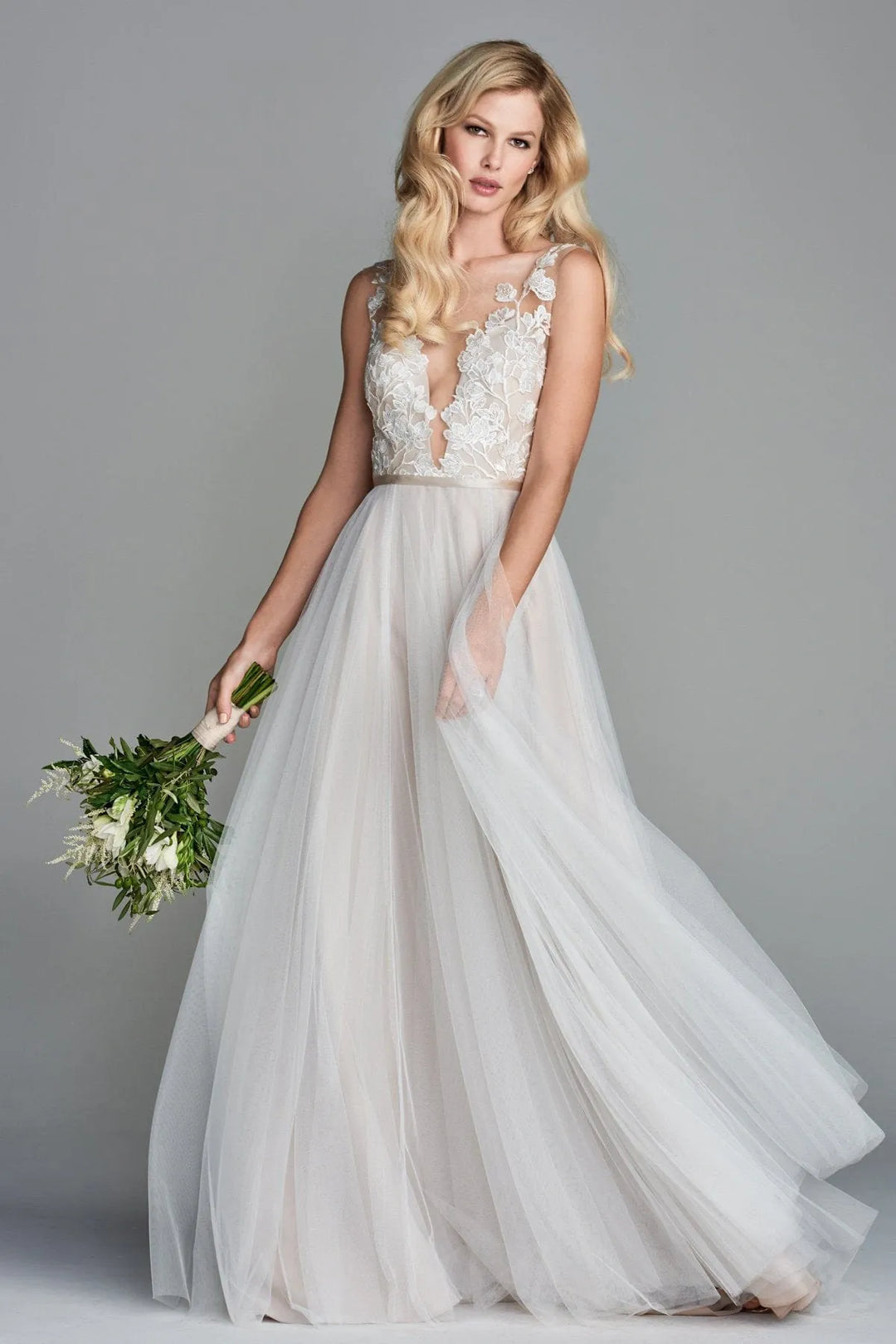 front of locket by watters juno latte colored tulle a-line wedding dress, showing the plunge bodice and breezy skirt
