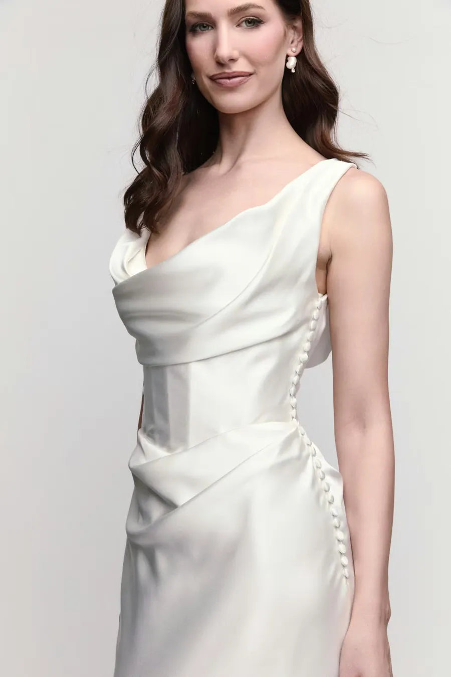 close up of locket by watters amaryllis ivory charmeuse sheath wedding dress featuring the scoop neckline and buttons down the side