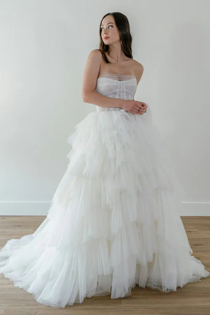 front of watters byrd ivory tulle ball gown with a strapless bodice and tiered ruffled skirt