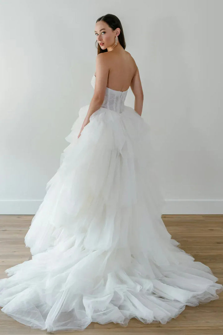 back of watters byrd ivory tulle ball gown with a strapless bodice and tiered ruffled skirt