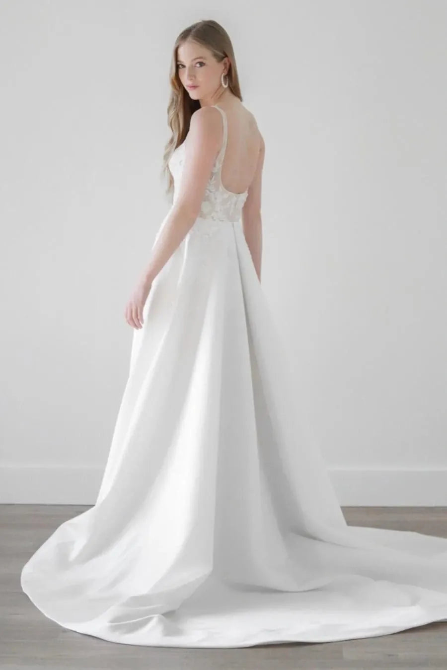 back of watters eislyn ivory satin a-line wedding dress with a lace bodice and chapel length train