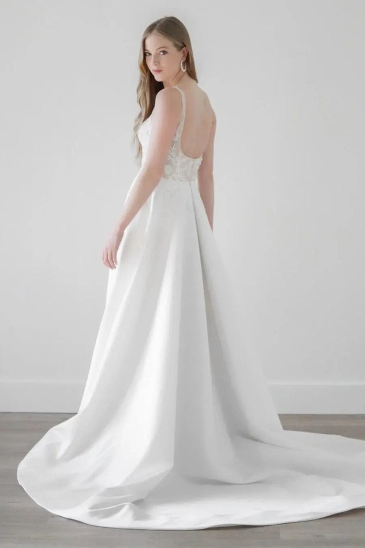 back of watters eislyn ivory satin a-line wedding dress with a lace bodice and chapel length train