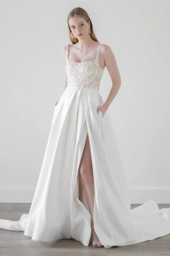 front of watters eislyn ivory satin a-line wedding dress with a lace bodice and slit in the skirt