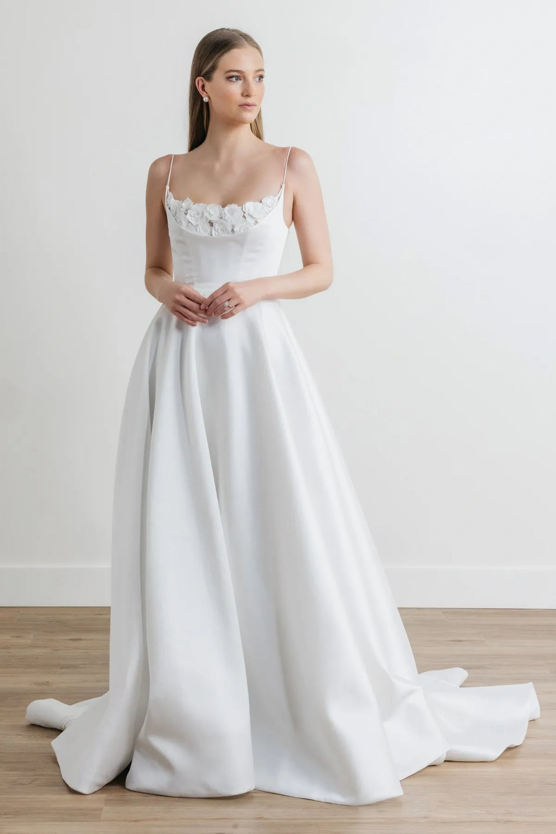 full front of watters hughes ivory mikado a-line wedding dress featuring floral lace on the scoop neckline, with thin straps