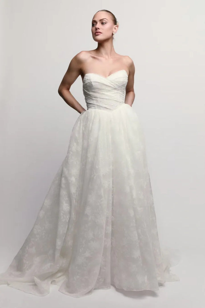 full front of watters isa ivory lace ball gown wedding dress with a drop waist and strapless neckline