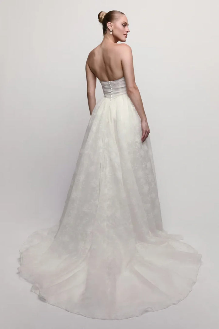 full back of watters isa ivory lace ball gown wedding dress with a drop waist and strapless neckline