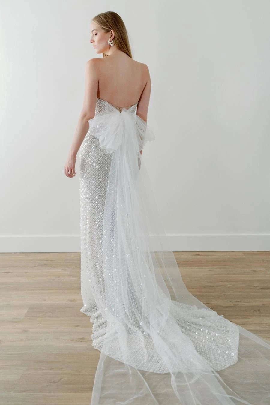 back of watters ondrea ivory beaded fitted wedding dress, showing the full back with a tulle bow at the back