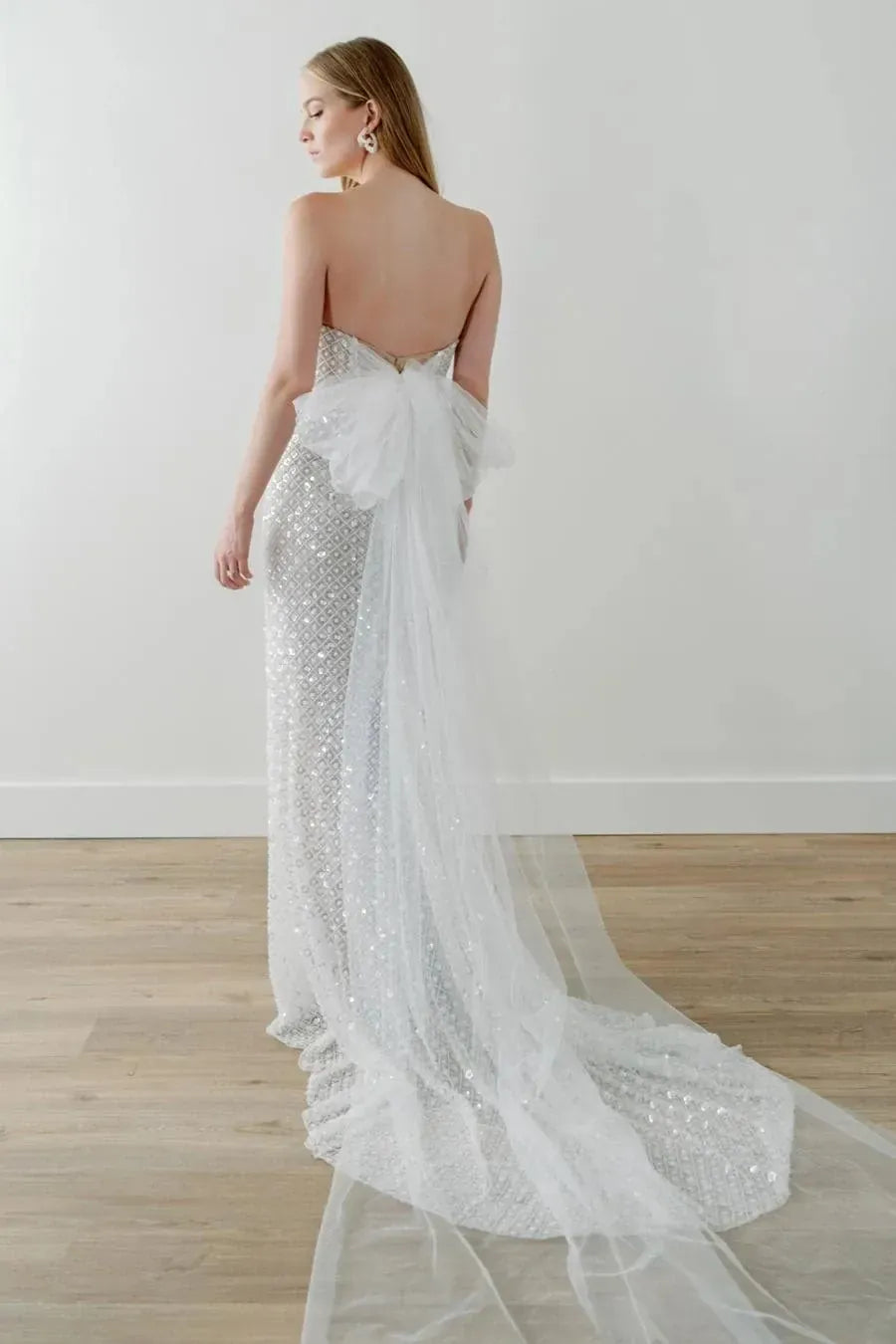 full back of watters ondrea champagne beaded fitted wedding dress featuring the tulle bow at the back and short train